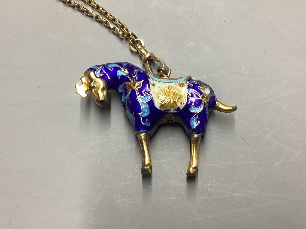 An enamelled gilt horse pendant on an unmarked yellow metal guard chain